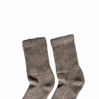 Pair of gray Yak  socks on a white background